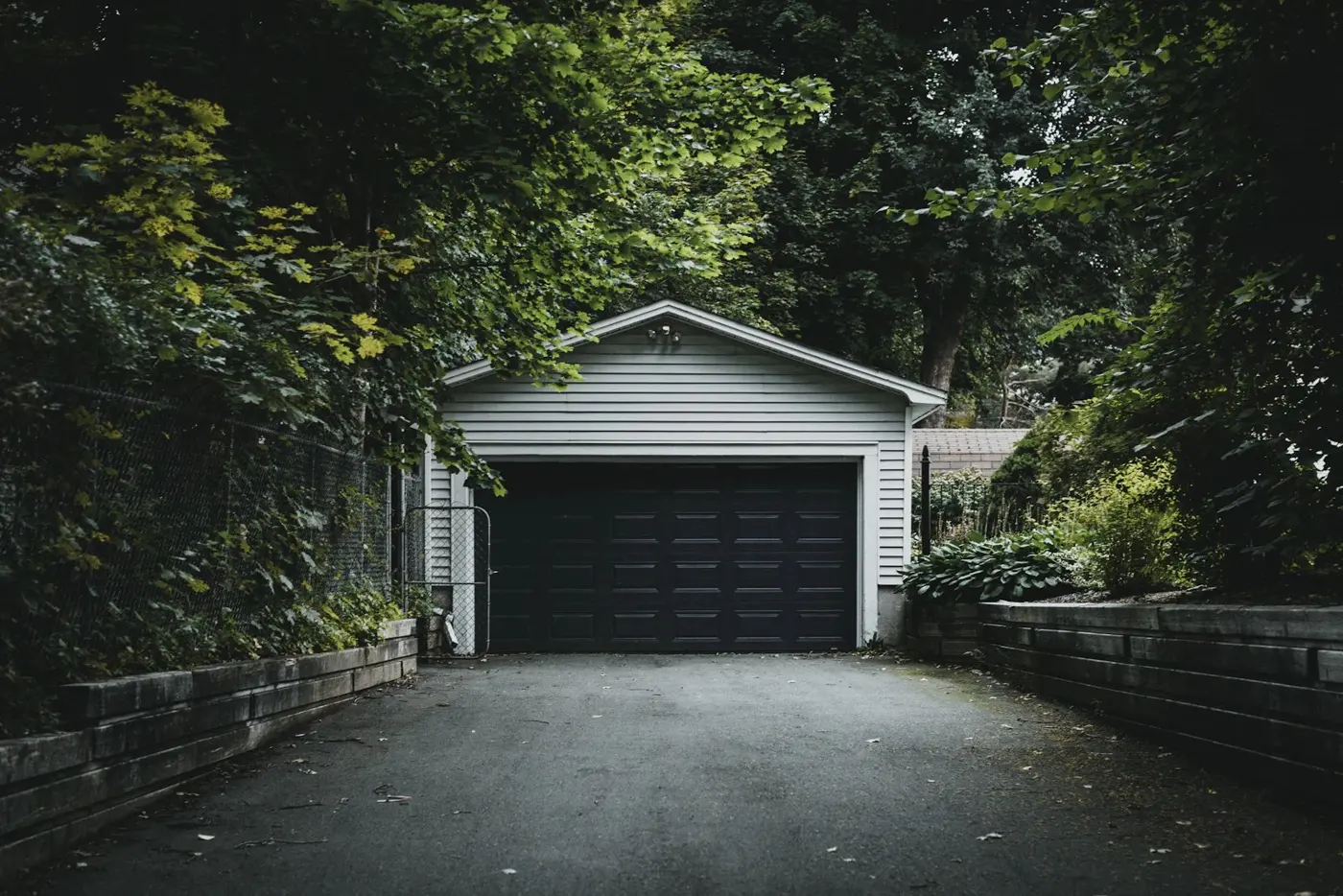 A detached garage and driveway in daylight